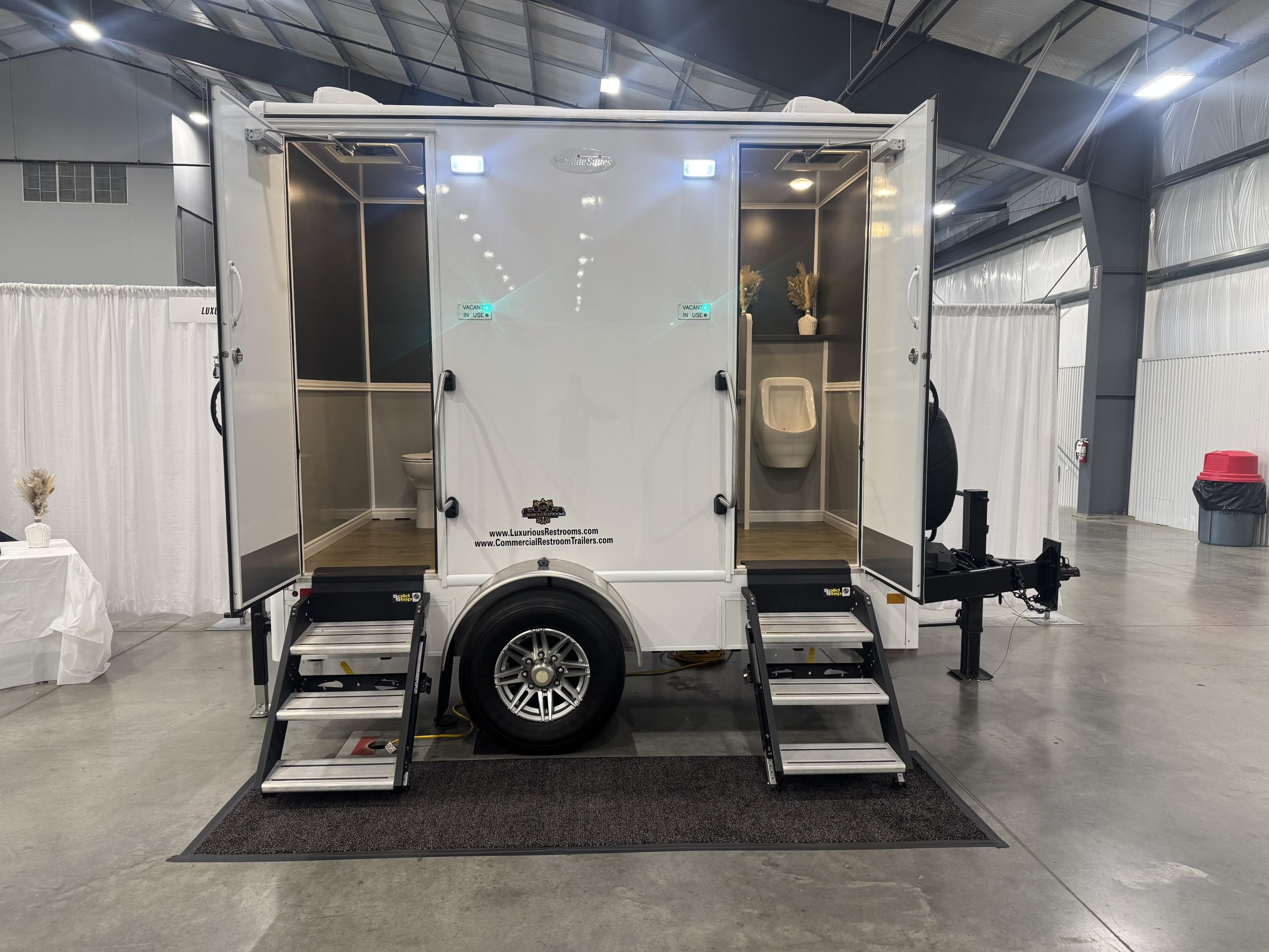 "2-stall luxury restroom trailer set up for outdoor wedding event"